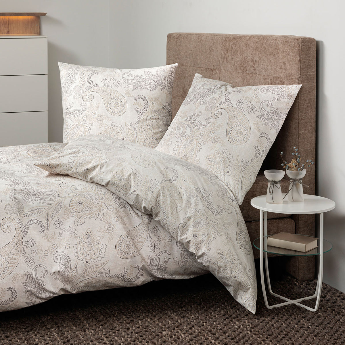 Janine Cortina Paisley Bettwäsche-Set in Natur Grau mit Paisleymuster auf Bett am Nachttisch